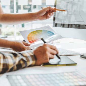 Design professionals looking at monitor