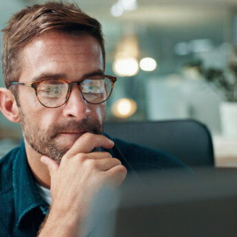 Computer, thinking and business man reading for problem solving, creative or software development. Planning, reflection and serious worker with inspiration, idea and web designer in startup office