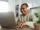 Happy mature Latin man using laptop at home - Technology and smart working concept