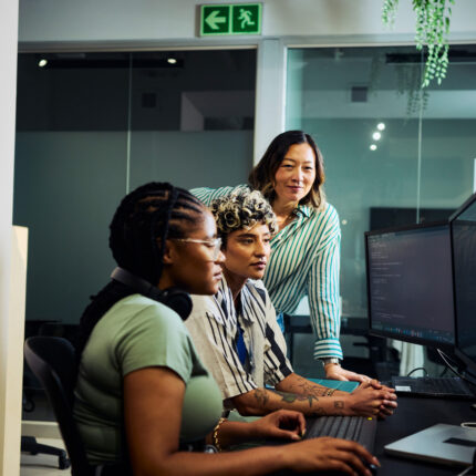 Team of programmers working on code at night in office