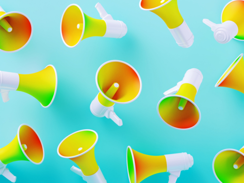 Colorful megaphones on blue background. Horizontal composition with copy space.