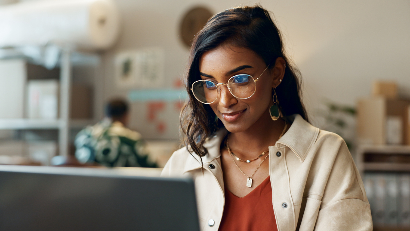 Woman, business and reading on laptop at work for research, feedback and supply chain for business. Indian, person and planning on pc for logistics, stock administration or package distribution data