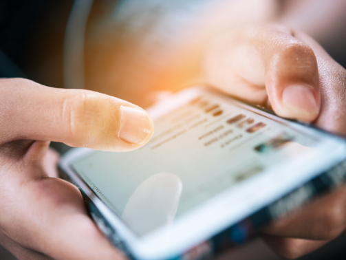 Midsection Of Person Using Mobile Phone