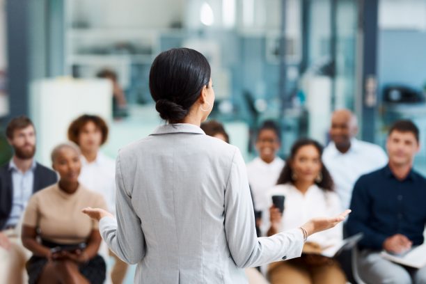 Rearview shot of an unrecognizable businesswoman giving a presentation in the office boardroom