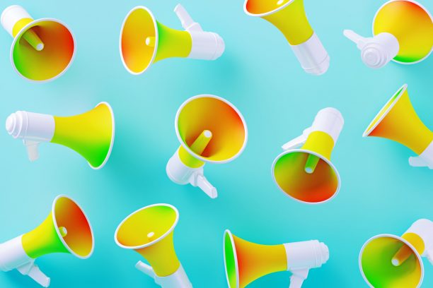 Colorful megaphones on blue background. Horizontal composition with copy space.